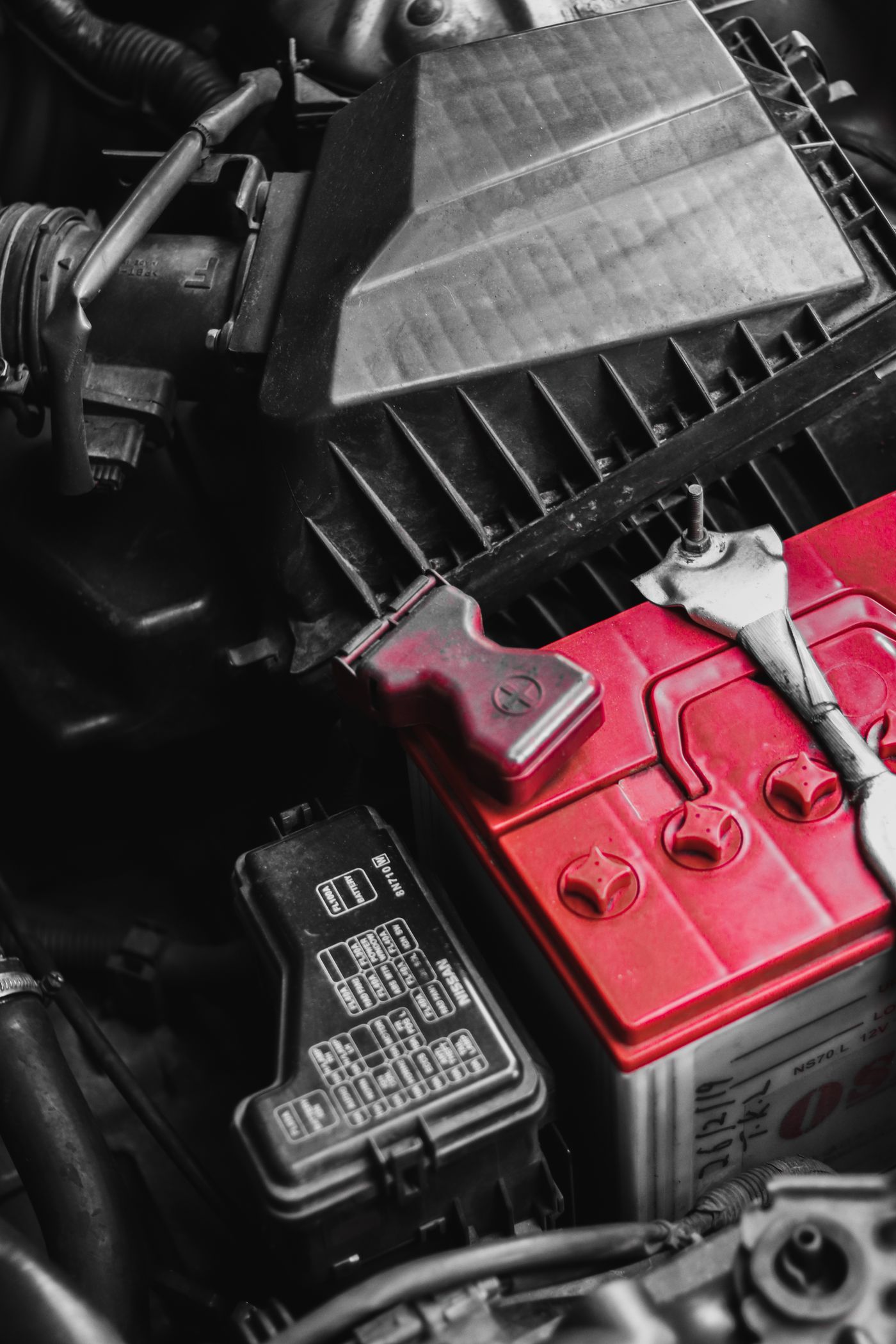 Close-up of a vehicle battery, terminals and electrical connections